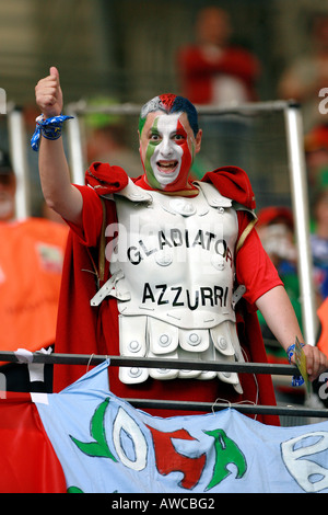 An Italian supporter dressed as a gladiator and with painted face in the crowd during the 2006 World Cup Stock Photo