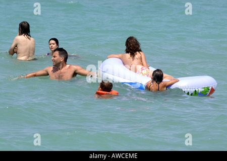 A group of people having fun in the sea on a summer's day Stock Photo