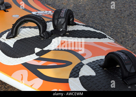 Surf board with bright graphics in orange and black Stock Photo