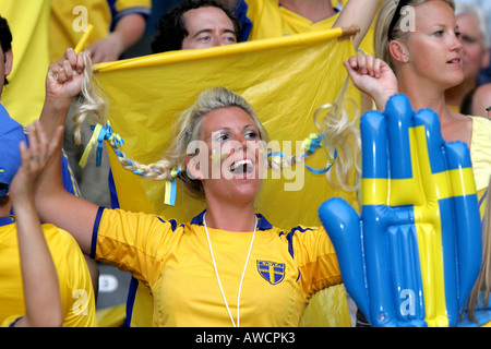 A female Swedish fan singing in the crowd during the 2006 World Cup Stock Photo