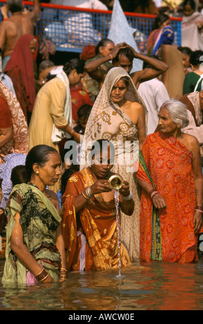 Women in the river Ganges at Varanasi during the Kartik Purnima festival in India Stock Photo