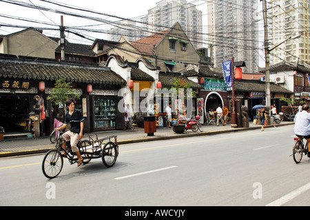 Street in the old part of Shanghai, cable chaos, little shops, traffic, new housing blocks, Shanghai, China, Asia Stock Photo