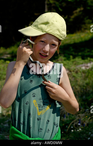 Eleven year old boy holding a Blindworm or Slow Worm (Anguis fragilis) Stock Photo
