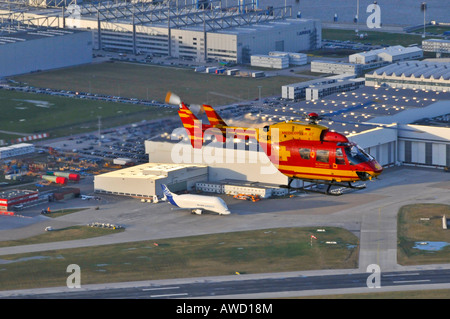 Eurocopter Medicopter BK 117 flying over the Airbus plant in Hamburg, Germany, Europe Stock Photo