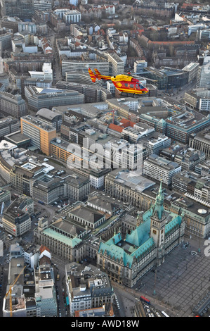 Eurocopter Medicopter BK 117 flying over city hall, Hamburg, Germany, Europe Stock Photo