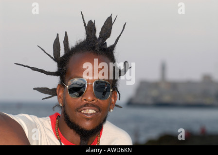 Portrait of a young man wearing sunglasses, Rasta-style, Malecón, Havana, Cuba, Caribbean, Americas Stock Photo