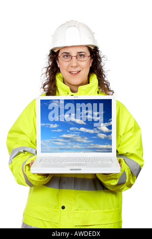 Female construction worker showing a laptop over a white background Note on screen image was also shot by me Stock Photo