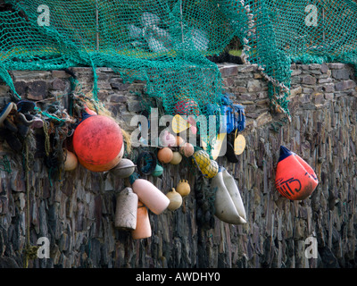 Cornish fishing floats and nets on a Cornish hedged wall Stock Photo
