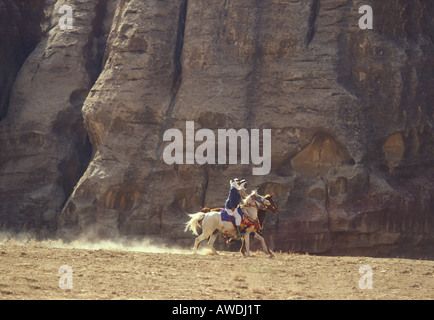 Raising dust as Arab horses and riders participate in a horse race in the Jordanian desert, near Petra, Jordan Stock Photo