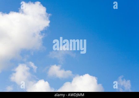 Fluffy white cumulus clouds in a blue sky indicating clement summer weather. England UK Britain Stock Photo