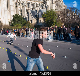 Skaters playing to the crowds outside Notre Dame Cathedral Paris France Europe Stock Photo