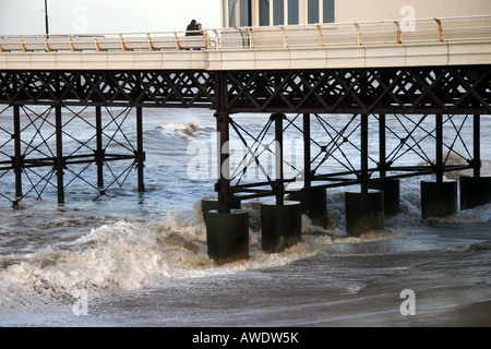 Side view of Cromer pier with waves crashing underneath Stock Photo