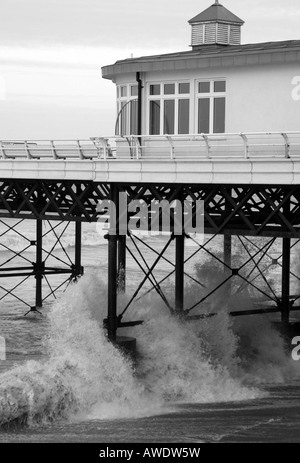 Side view of Cromer pier with waves crashing underneath Stock Photo