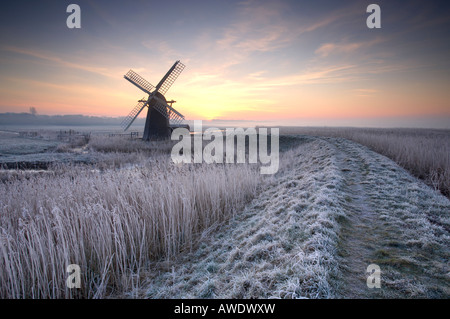 Cold Hoar Frosted sunrise at Herringfleet windmill on the Norfolk & Suffolk Broads Stock Photo