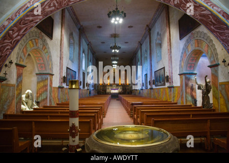 CALIFORNIA Santa Barbara Holy water basin Mission Santa Barbara church interior center aisle sanctuary rows of pews Stock Photo