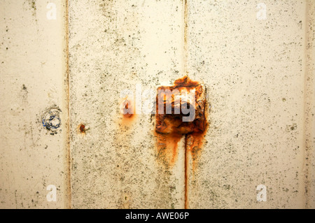 Rust covered bolt on a wooden beach hut Stock Photo