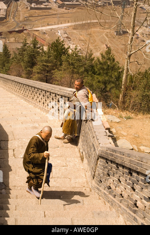 Two pilgrims climbing up the steps to a temple in Wutai Shan, People's Republic of China Stock Photo