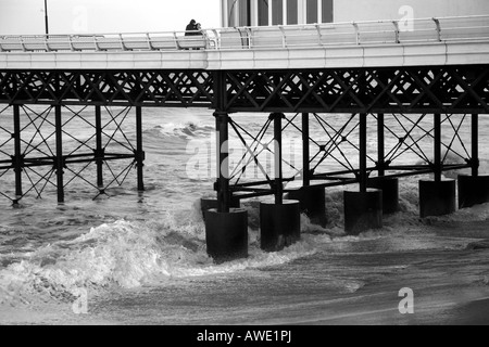 Side view of Cromer pier with waves crashing underneath Stock Photo