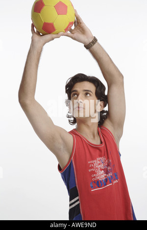 ANG200564 Teenage boy holding football with both hands and trying to throw MR 687T