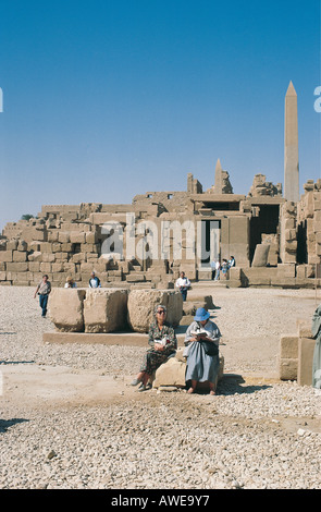 Two lady tourists sitting in the Temple of Karnak on the east bank of the River Nile near Luxor Egypt Stock Photo
