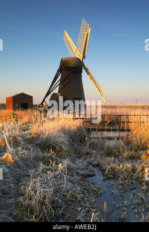 Cold Hoar Frosted sunrise at Herringfleet windmill on the Norfolk & Suffolk Broads Stock Photo