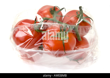 some TOMATOES panicle of tomato wrapped in cling film plastic wrap folie sell selling box fresh sheet on white Background cutout Stock Photo