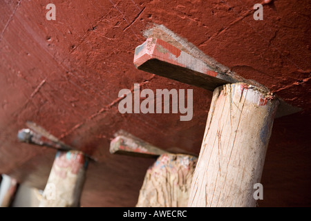 Wooden posts & wedges, under ship keel,  used in ship building yard to stablise a vessel in dry dock. Ship repair yard Macduff, North East Scotland UK Stock Photo