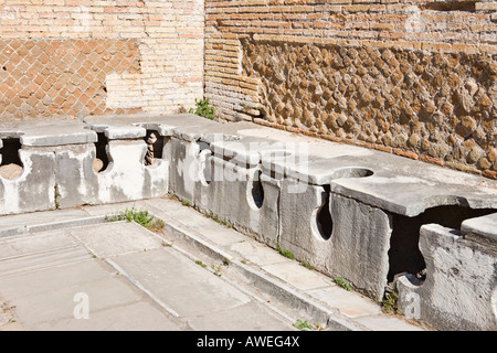 Ancient public toilets at Ostia Antica archaeological site, Rome, Italy, Europe Stock Photo