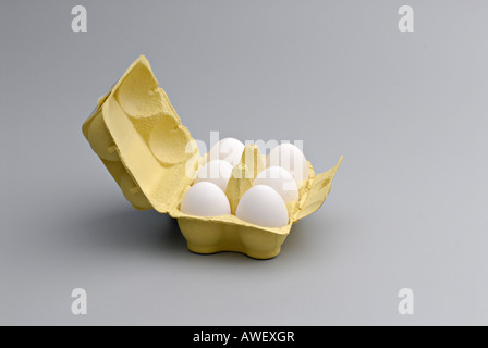 Six white eggs in open cardboard egg box Stock Photo