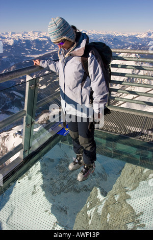 Tourist standing on glass plate, looking down, Skywalk, Dachstein Massif, Styria, Austria, Europe Stock Photo