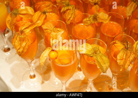 Champagne glasses garnished with Chinese lantern fruit Stock Photo