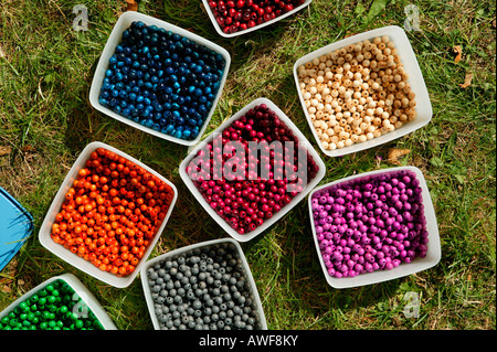 Containers filled with colourful beads for crafting Stock Photo