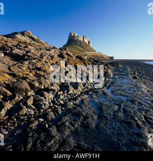 View towards Lindisfarne Castle from the beach on Holy Island, Northumberland, England Stock Photo
