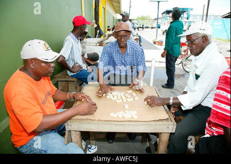 Men playing dominos at the market square in Georgetown, Guyana, South America Stock Photo