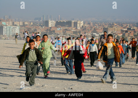 Class trip to the pyramids, Cairo blanketed in smog in the background, Egypt, North Africa, Africa Stock Photo