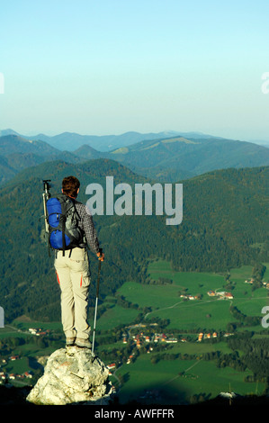 Man standing on a rock looking into the valley, Breitenstein Mountain, Bavarian foothills, Wendelstein Group, Upper Bavaria, Ba Stock Photo