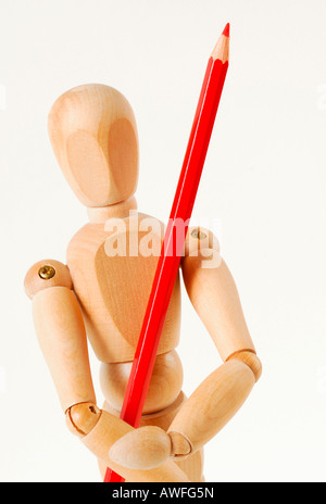 Jointed doll with red pencil Stock Photo