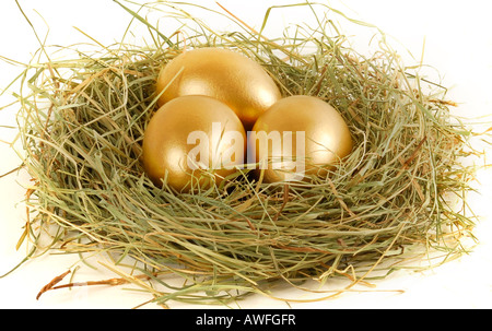 Three golden eggs in an Easter nest Stock Photo