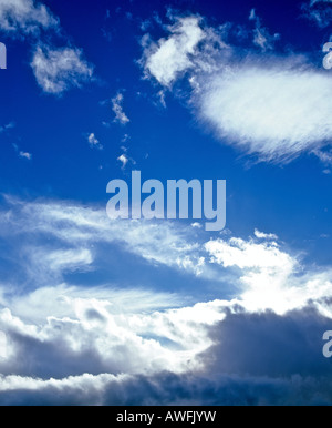 Cumulus and cirrus clouds in a blue sky Stock Photo