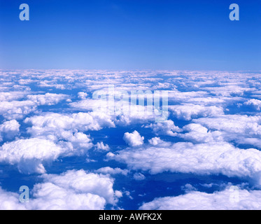 Cumulus clouds in a blue sky viewed from airplane window Stock Photo