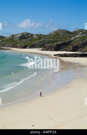 dh Highland Northwest coast OLDSHOREMORE BAY SUTHERLAND SCOTLAND Woman walking sands stunning scottish beaches scene tourist idyllic beach highlands Stock Photo