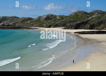 dh  OLDSHOREMORE BAY SUTHERLAND Woman walking white sands bay coast scottish highlands beach west highland scotland summer uk single person walk Stock Photo