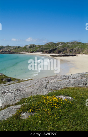 dh Scottish Northwest coast OLDSHOREMORE BAY SUTHERLAND West Highlands beach Woman walking along white sands tourist summer blue sky scotland scenic Stock Photo