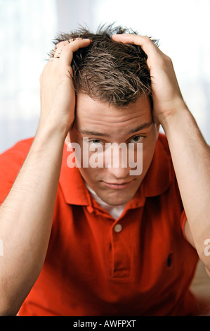 Young man tears at his hair Stock Photo