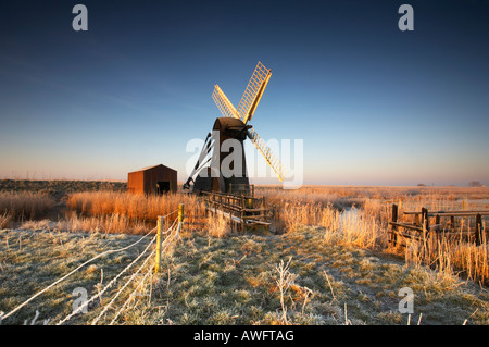 Cold Hoar Frosted sunrise at Herringfleet windmill on the Norfolk & Suffolk Broads Stock Photo