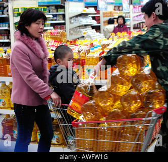 Chinese consumers buy bottle cooking oil in a supermarket in Beijing China. 12-Mar-2008 Stock Photo