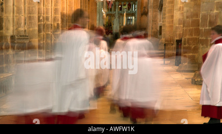 The choirboys of gloucester cathedral, blurred as they walk away from the camera Stock Photo