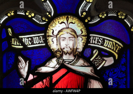 A stained glass window in Gloucester cathedral of Jesus with a halo Stock Photo