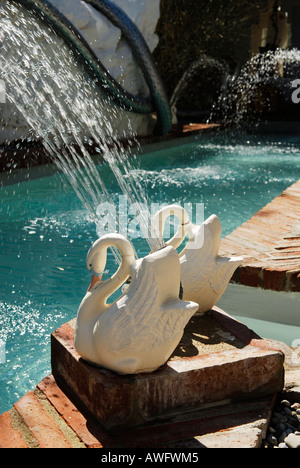 sculptured swans serve as water fountains at the swimming pool in the garden of the house of  surrealist painter Salvador Dali Stock Photo