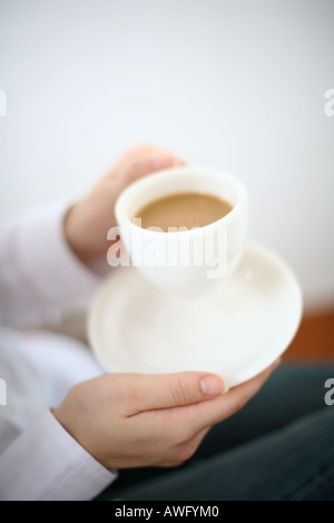 A young woman drinking a cup of coffee Stock Photo